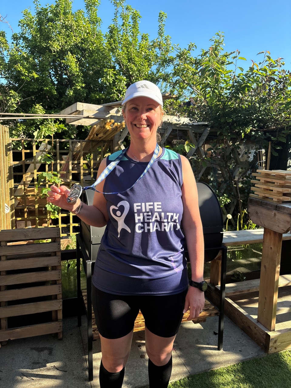 Marathon runner Debbie with medal