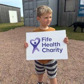 Boy Holding Charity Sign
